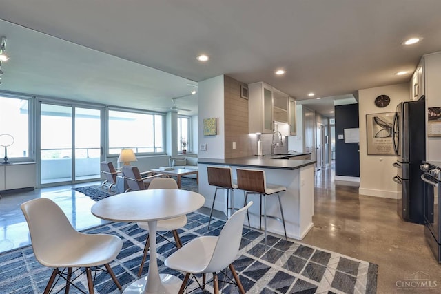 2401 Ingleside Ave Unit 10D, Cincinnati, OH 45206 - dining area featuring baseboards, finished concrete flooring, and recessed lighting