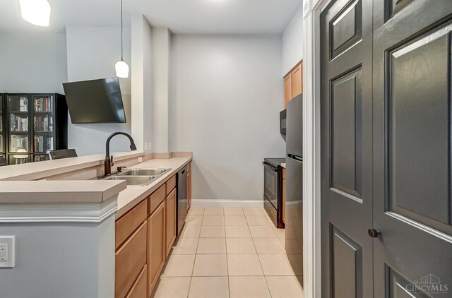 2110 Fulton Ave Unit 3, Cincinnati, OH 45206 - kitchen with a sink, dishwasher, a peninsula, light tile patterned flooring, and decorative light fixtures