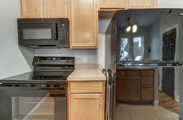 2110 Fulton Ave Unit 3, Cincinnati, OH 45206 - kitchen with black appliances, tile patterned flooring, light brown cabinets, and light countertops