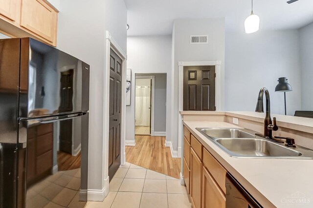 2110 Fulton Ave Unit 3, Cincinnati, OH 45206 - kitchen featuring freestanding refrigerator, a sink, light tile patterned flooring, light countertops, and pendant lighting
