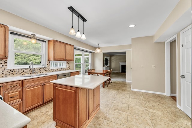 8912 Chapelsquare Ln, Symmes Twp, OH 45249 - kitchen featuring a sink, stainless steel dishwasher, backsplash, light countertops, and brown cabinetry