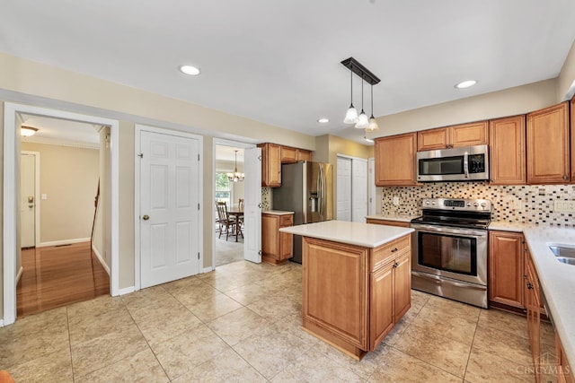 8912 Chapelsquare Ln, Symmes Twp, OH 45249 - kitchen featuring appliances with stainless steel finishes, decorative backsplash, light countertops, a kitchen island, and a chandelier