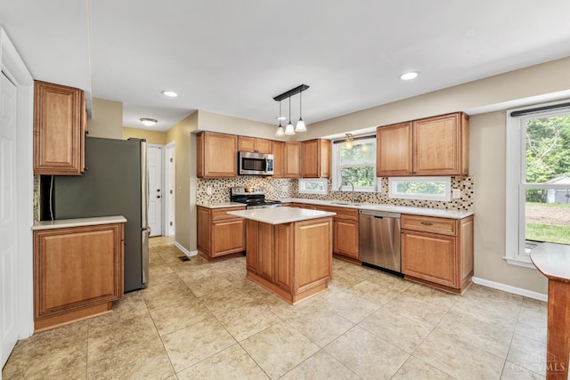 8912 Chapelsquare Ln, Symmes Twp, OH 45249 - kitchen featuring stainless steel appliances, decorative backsplash, a sink, light countertops, and brown cabinets