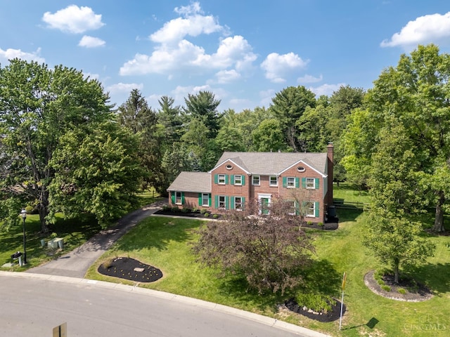 8912 Chapelsquare Ln, Symmes Twp, OH 45249 - view of front of home featuring a chimney, a front lawn, and a view of trees