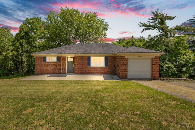 5386 Day Rd, Colerain Twp, OH 45251 - single story home featuring a garage, driveway, a lawn, brick siding, and a patio