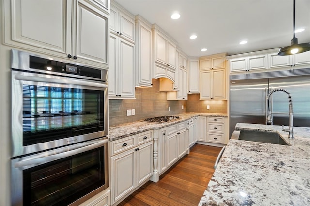 5757 W Fork Rd, Green Twp, OH 45247 - kitchen featuring appliances with stainless steel finishes, a sink, dark wood-style floors, backsplash, and recessed lighting