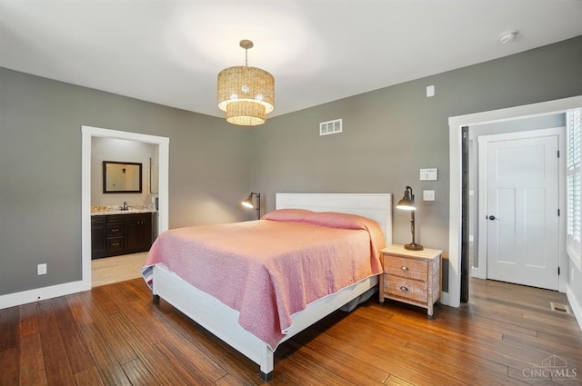 5757 W Fork Rd, Green Twp, OH 45247 - bedroom with dark wood-type flooring, baseboards, and connected bathroom
