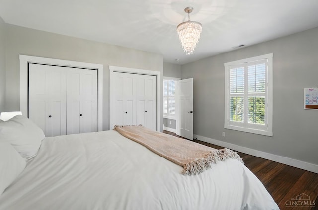 5757 W Fork Rd, Green Twp, OH 45247 - bedroom featuring baseboards, multiple windows, two closets, and a chandelier