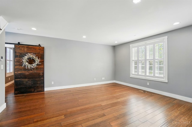 5757 W Fork Rd, Green Twp, OH 45247 - spare room featuring hardwood / wood-style flooring, baseboards, a barn door, and recessed lighting