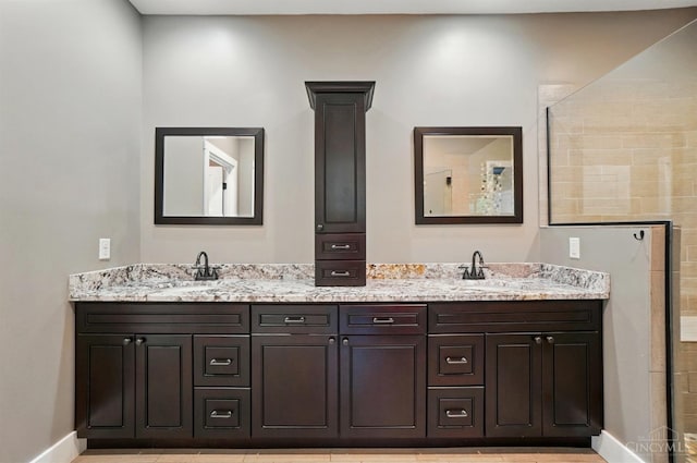 5757 W Fork Rd, Green Twp, OH 45247 - bathroom featuring double vanity, baseboards, and a tile shower