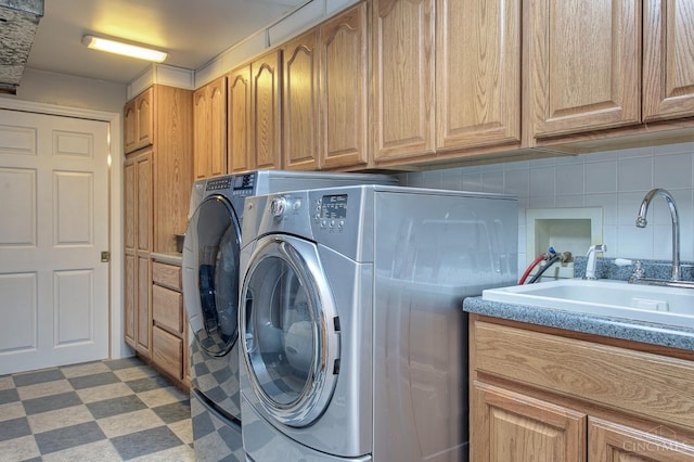 3169 John Gray Rd, Colerain Twp, OH 45251 - laundry area with cabinet space, washing machine and clothes dryer, and light flooring