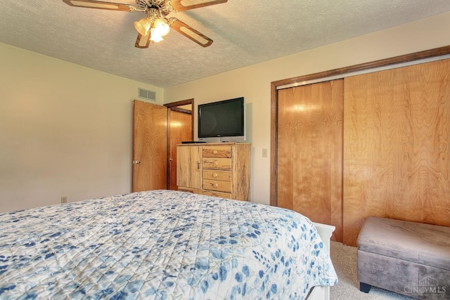 3169 John Gray Rd, Colerain Twp, OH 45251 - carpeted bedroom with a closet, a textured ceiling, and ceiling fan