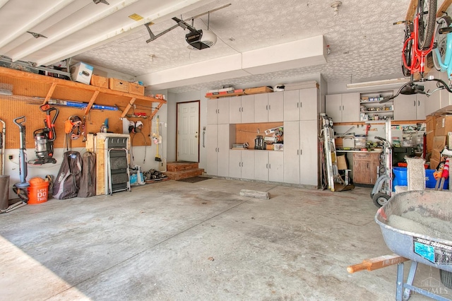 3169 John Gray Rd, Colerain Twp, OH 45251 - garage with a garage door opener and a workshop area