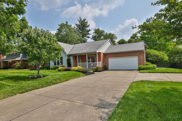 8750 E Kemper Rd, Symmes Twp, OH 45249 - view of front of house with brick siding, a porch, concrete driveway, a garage, and a front lawn