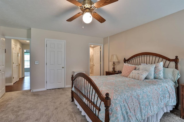 8750 E Kemper Rd, Symmes Twp, OH 45249 - carpeted bedroom with baseboards, ceiling fan, and ensuite bath