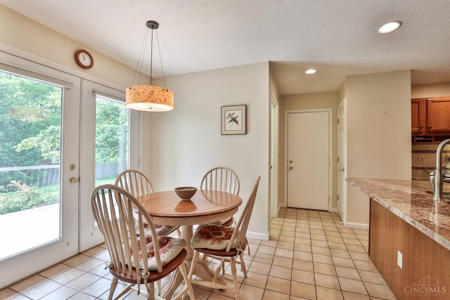 8750 E Kemper Rd, Symmes Twp, OH 45249 - dining room featuring light tile patterned floors, recessed lighting, baseboards, and a textured ceiling