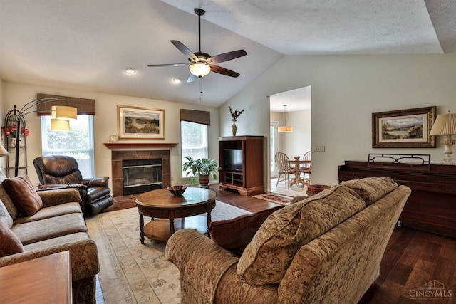 8750 E Kemper Rd, Symmes Twp, OH 45249 - living area with wood finished floors, ceiling fan, vaulted ceiling, and a tile fireplace