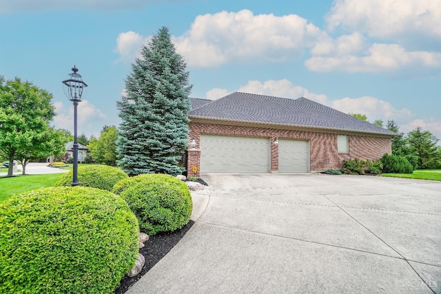 4625 Guildford Dr, West Chester, OH 45069 - view of front of property featuring concrete driveway, an attached garage, and brick siding