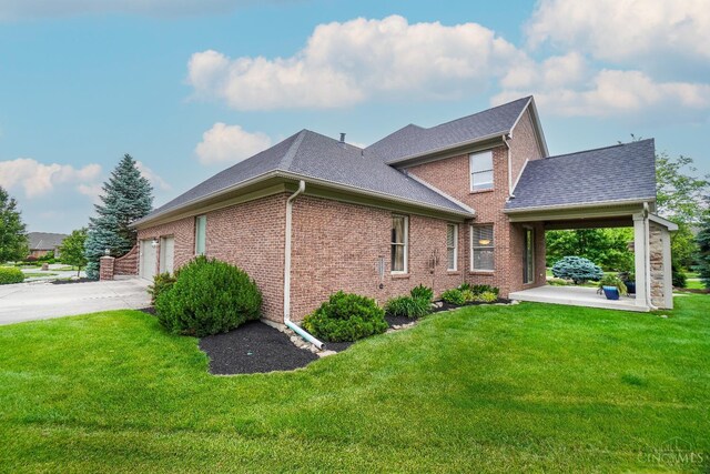 4625 Guildford Dr, West Chester, OH 45069 - view of property exterior with a lawn, brick siding, concrete driveway, and roof with shingles