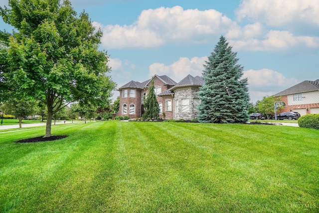 4625 Guildford Dr, West Chester, OH 45069 - view of front facade featuring a front yard and brick siding