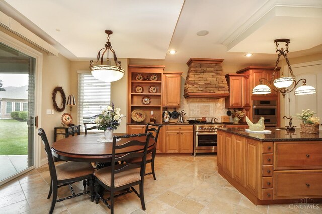 4625 Guildford Dr, West Chester, OH 45069 - kitchen featuring appliances with stainless steel finishes, a sink, open shelves, tasteful backsplash, and decorative light fixtures