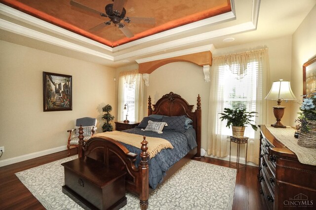 4625 Guildford Dr, West Chester, OH 45069 - bedroom featuring a raised ceiling, multiple windows, dark wood-type flooring, and crown molding