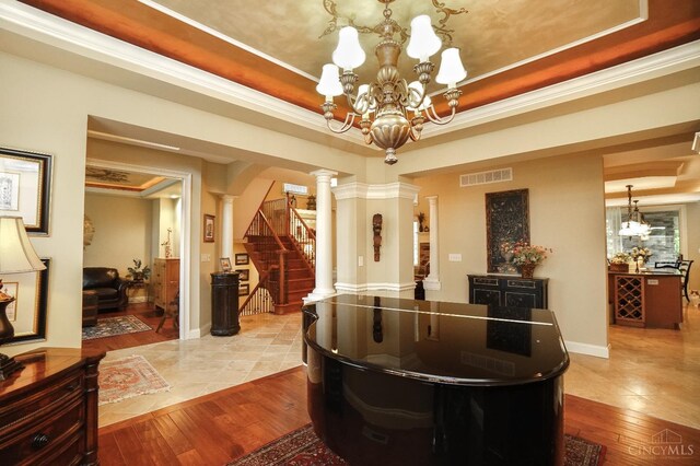 4625 Guildford Dr, West Chester, OH 45069 - welcome area with a chandelier, decorative columns, stairway, and ornamental molding