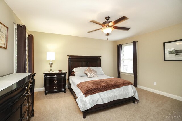 4625 Guildford Dr, West Chester, OH 45069 - bedroom with light carpet, baseboards, and a ceiling fan