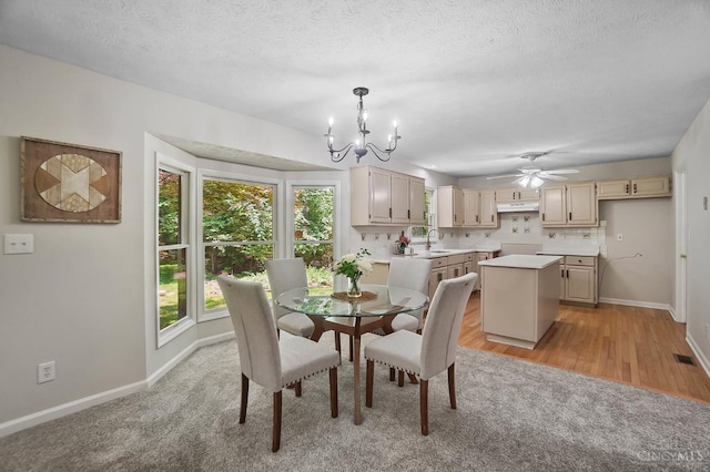 2193 Phillips Rd, Union Twp, OH 45036 - dining space with healthy amount of natural light, a chandelier, ceiling fan, a textured ceiling, and light wood-style floors