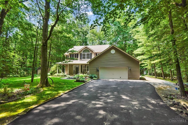 2193 Phillips Rd, Union Twp, OH 45036 - view of front of home with asphalt driveway, an attached garage, a front lawn, and a porch