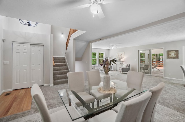 2193 Phillips Rd, Union Twp, OH 45036 - dining area featuring a ceiling fan, stairway, light wood-type flooring, a textured ceiling, and light carpet