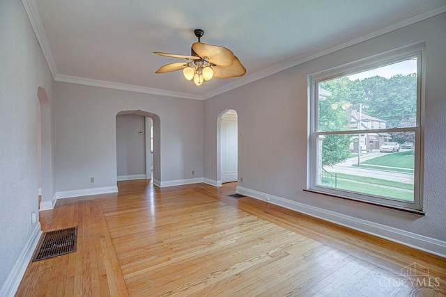 3947 Ruth Ln, Cheviot, OH 45211 - spare room featuring arched walkways, healthy amount of natural light, light wood-style flooring, and ornamental molding