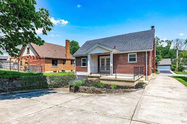 3947 Ruth Ln, Cheviot, OH 45211 - bungalow-style house featuring french doors, roof with shingles, brick siding, a chimney, and a garage