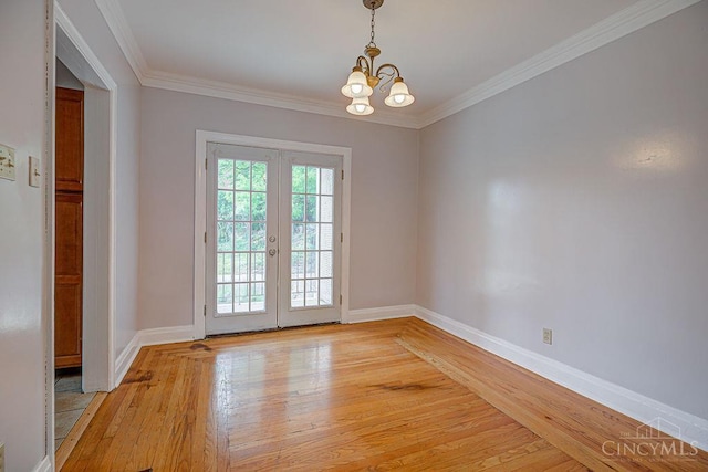 3947 Ruth Ln, Cheviot, OH 45211 - unfurnished room featuring light wood finished floors, a chandelier, french doors, and crown molding