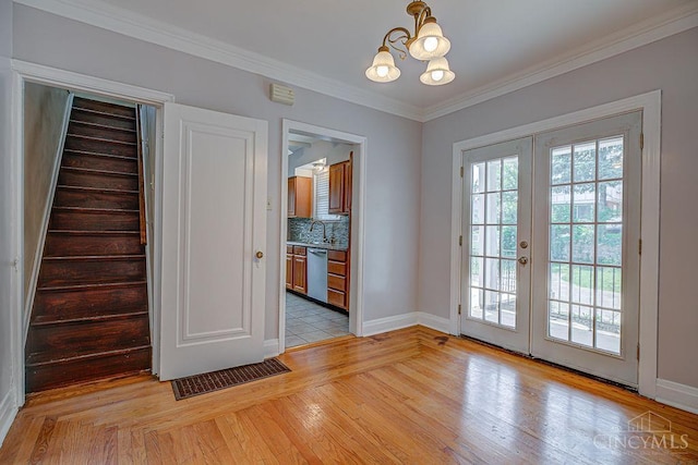 3947 Ruth Ln, Cheviot, OH 45211 - entryway with a chandelier, french doors, crown molding, stairway, and light wood finished floors