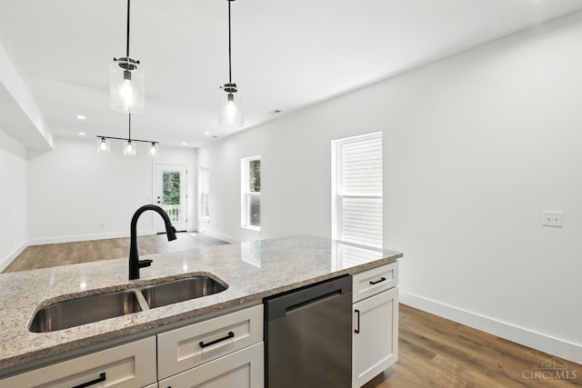 2356 Concord St, Cincinnati, OH 45206 - kitchen with stainless steel dishwasher, white cabinets, decorative light fixtures, light wood-style floors, and light stone counters