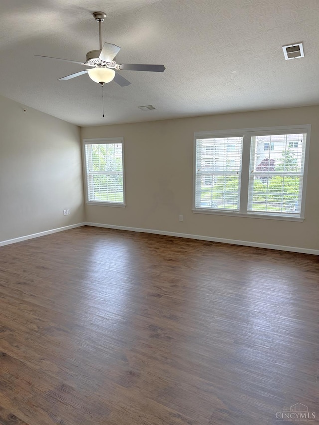4572 Saddlecloth Ct, Batavia Twp, OH 45103 - spare room featuring dark wood-style flooring, a ceiling fan, baseboards, and a textured ceiling