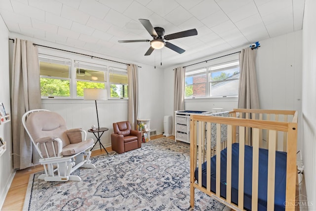 6530 Cliff Ridge Ln, Columbia Twp, OH 45213 - bedroom with a crib, wood finished floors, and ceiling fan