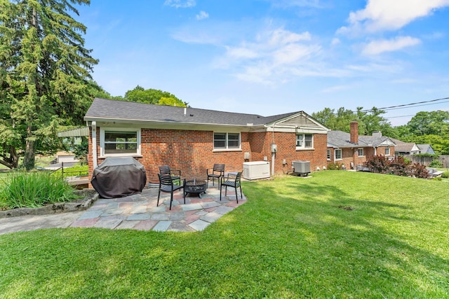 6530 Cliff Ridge Ln, Columbia Twp, OH 45213 - back of house featuring central AC, brick siding, a patio, an outdoor fire pit, and a yard