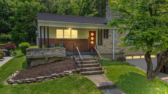 6530 Cliff Ridge Ln, Columbia Twp, OH 45213 - view of front of house featuring covered porch, a front lawn, brick siding, and a garage