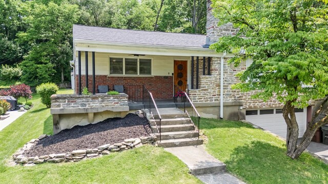 6530 Cliff Ridge Ln, Columbia Twp, OH 45213 - view of front facade with a porch, a front lawn, brick siding, and a garage