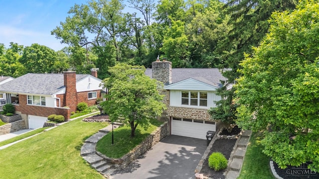 6530 Cliff Ridge Ln, Columbia Twp, OH 45213 - view of front facade featuring asphalt driveway, a garage, a chimney, stone siding, and a front yard