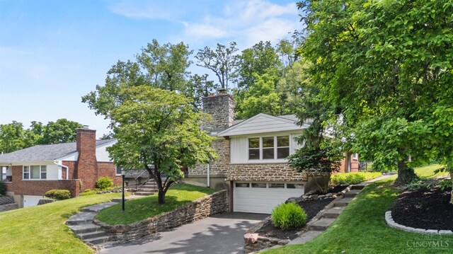 6530 Cliff Ridge Ln, Columbia Twp, OH 45213 - view of front of house with a garage, driveway, a front lawn, and a chimney