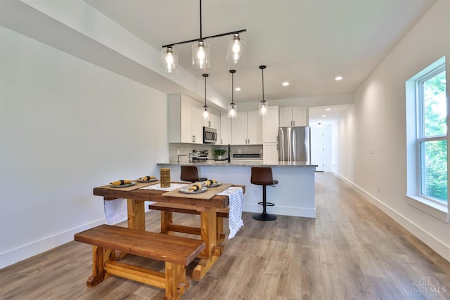 2351 Concord St, Cincinnati, OH 45206 - kitchen with appliances with stainless steel finishes, a peninsula, healthy amount of natural light, white cabinetry, and recessed lighting