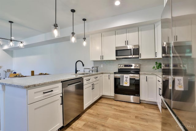 2351 Concord St, Cincinnati, OH 45206 - kitchen with stainless steel appliances, a peninsula, white cabinetry, and tasteful backsplash