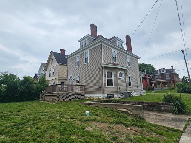 2002 Clarion Ave, Cincinnati, OH 45207 - back of property with a chimney, a yard, and a wooden deck