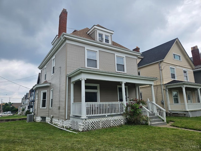 2002 Clarion Ave, Cincinnati, OH 45207 - american foursquare style home featuring covered porch, a front yard, and a chimney