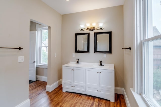 2002 Clarion Ave, Cincinnati, OH 45207 - full bathroom featuring wood finished floors, double vanity, and a chandelier
