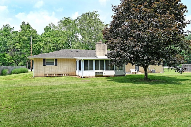 9660 N Dixie Hwy, Franklin Twp, OH 45005 - view of front facade featuring a sunroom, a chimney, brick siding, and roof with shingles