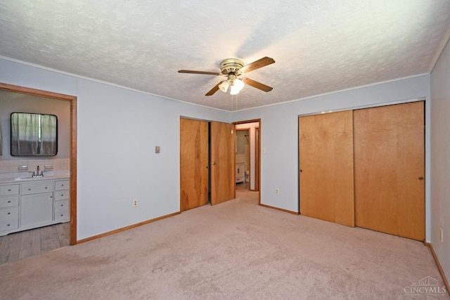 9660 N Dixie Hwy, Franklin Twp, OH 45005 - unfurnished bedroom featuring light carpet, baseboards, ensuite bath, a textured ceiling, and ornamental molding